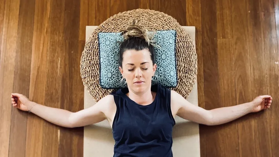 woman lying with arms outstretched